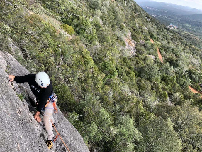 Climber at one of the slabby sectors in Rocha da Pena
