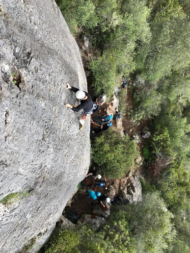Climber leading up a route