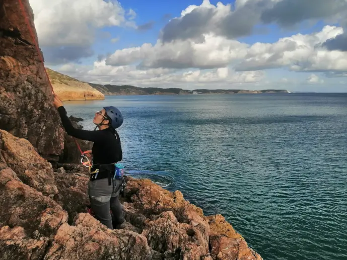 Climber belaying a leader in Sagres