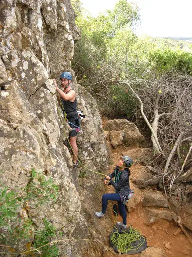 Climber clipping the first bolt during a lead climbing course in Lagos