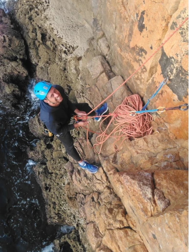 Climbers preparing anchors during a rope access course.