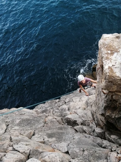 Second climbing up to the top of a sea cliff