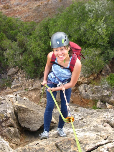 Climber abseiling at Lagos climbing area during top rope course