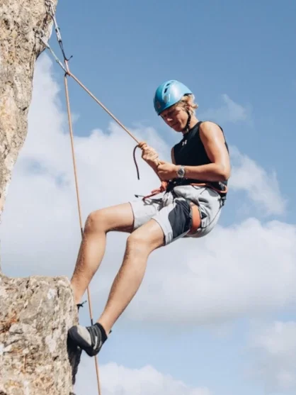 Person climbing at the Lagos area in Portugal.